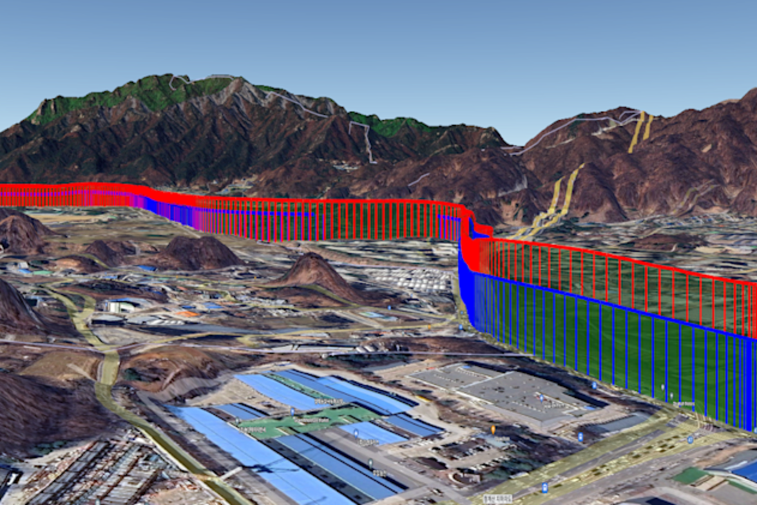 3D map of mountains and urban areas, with an overlaid red, blue, and green structure indicating an elevation profile.